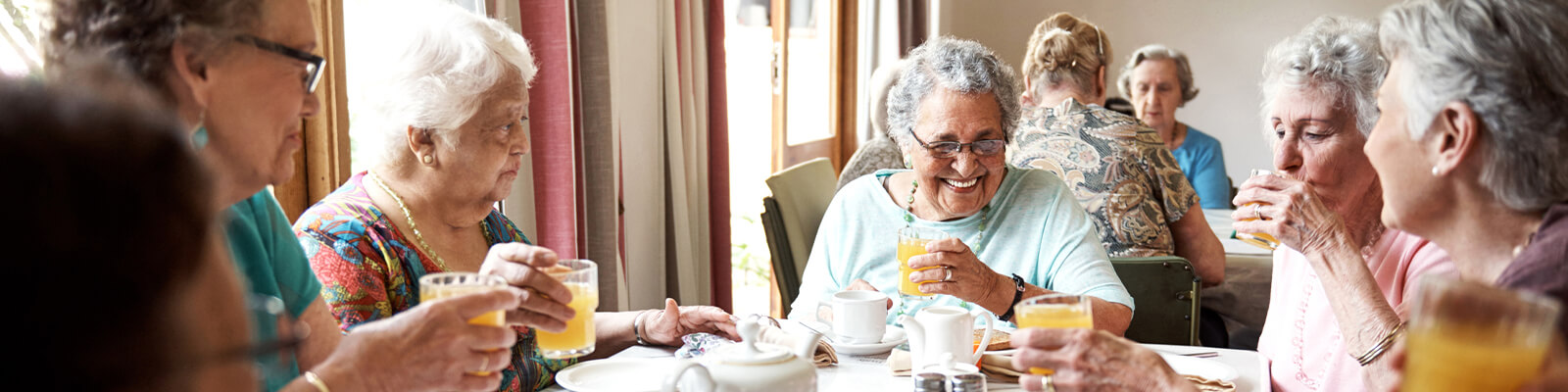 Senior women enjoying breakfast in a dining area