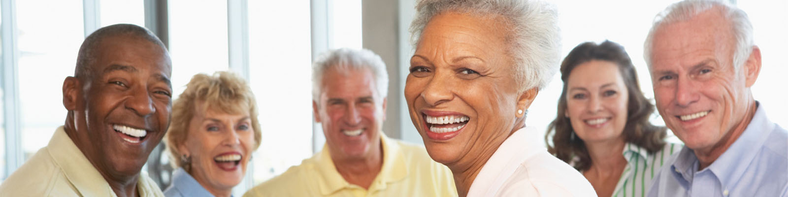 Senior men and women sitting together and smiling at a table